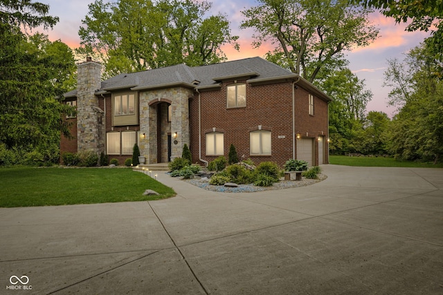 6230 E 56th St, Indianapolis, IN 46226 - view of front of house with a garage, concrete driveway, a lawn, a chimney, and stone siding