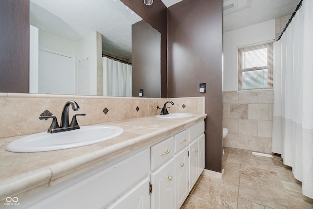 5236 Honey Comb Ln, Indianapolis, IN 46221 - full bathroom featuring tile walls, double vanity, and toilet
