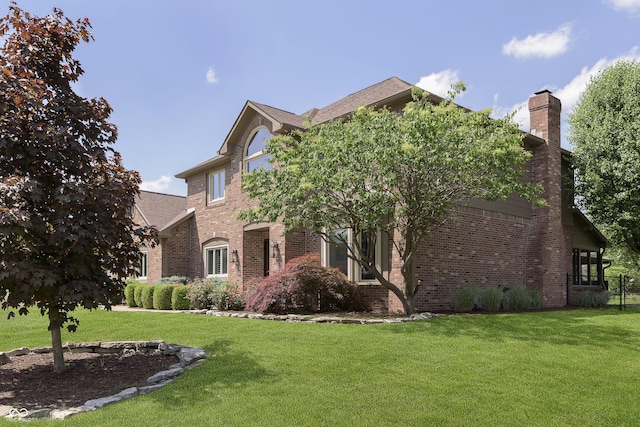 7430 Franklin Parke Woods, Indianapolis, IN 46259 - view of front facade featuring brick siding, a front lawn, and a chimney