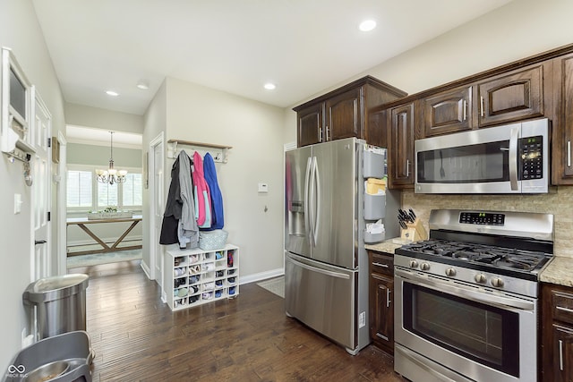 7430 Franklin Parke Woods, Indianapolis, IN 46259 - kitchen with appliances with stainless steel finishes, a chandelier, dark brown cabinetry, decorative backsplash, and dark wood-type flooring