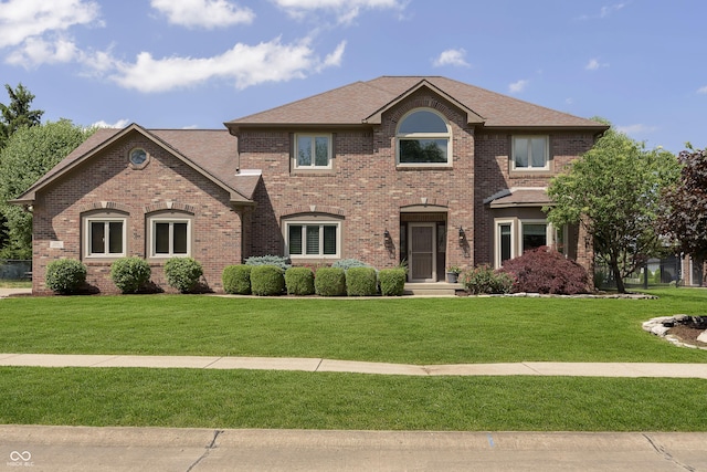 7430 Franklin Parke Woods, Indianapolis, IN 46259 - view of front of house featuring brick siding, a front yard, and a shingled roof