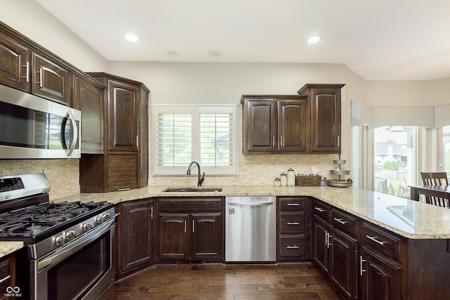 7430 Franklin Parke Woods, Indianapolis, IN 46259 - kitchen with appliances with stainless steel finishes, a sink, dark wood-style flooring, backsplash, and dark brown cabinets