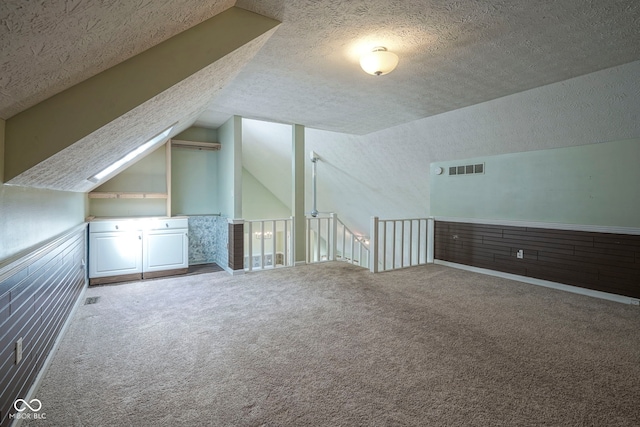 858 Cedar Wood, Carmel, IN 46032 - additional living space featuring vaulted ceiling, a textured ceiling, and carpet floors