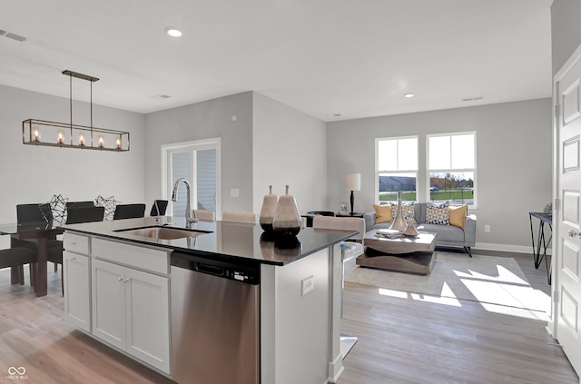 6683 Halsey St, Zionsville, IN 46077 - kitchen featuring a sink, stainless steel dishwasher, dark countertops, light wood finished floors, and recessed lighting