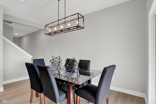 6683 Halsey St, Zionsville, IN 46077 - dining area featuring light wood-style flooring, baseboards, and a chandelier
