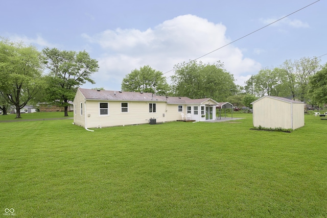 125 S Alfonte St, Ingalls, IN 46048 - rear view of property with a yard, a patio, and an outbuilding