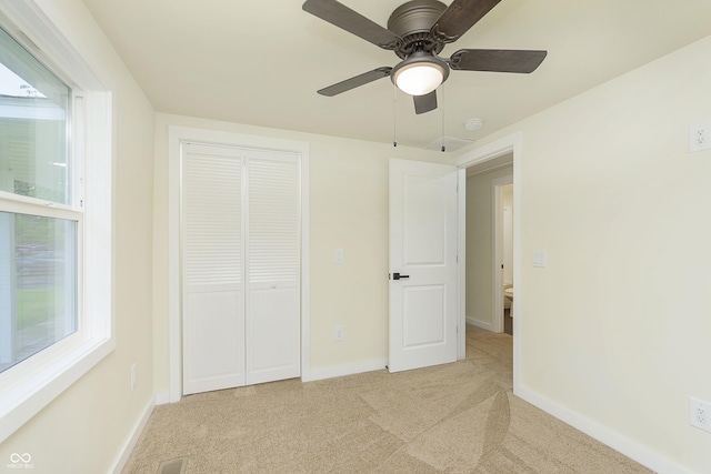 125 S Alfonte St, Ingalls, IN 46048 - unfurnished bedroom with light carpet, a closet, baseboards, and ceiling fan
