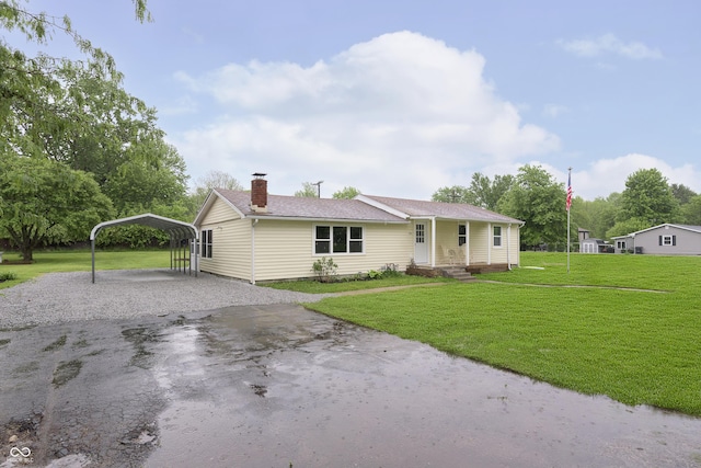 125 S Alfonte St, Ingalls, IN 46048 - single story home with driveway, a detached carport, a front yard, and a chimney
