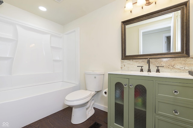 125 S Alfonte St, Ingalls, IN 46048 - full bath with toilet, wood finished floors, vanity, backsplash, and baseboards