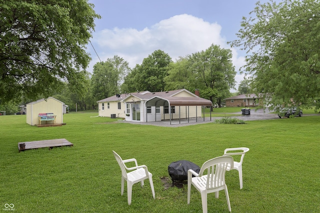 125 S Alfonte St, Ingalls, IN 46048 - back of property featuring a lawn, an outdoor fire pit, and a chimney