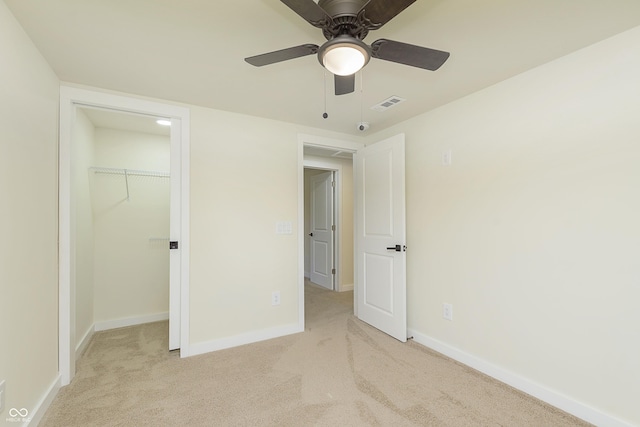 125 S Alfonte St, Ingalls, IN 46048 - unfurnished bedroom with carpet, baseboards, a walk in closet, a closet, and a ceiling fan