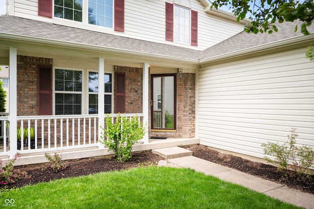 6026 Pennyworth Cir, Indianapolis, IN 46203 - doorway to property featuring a porch, roof with shingles, and brick siding