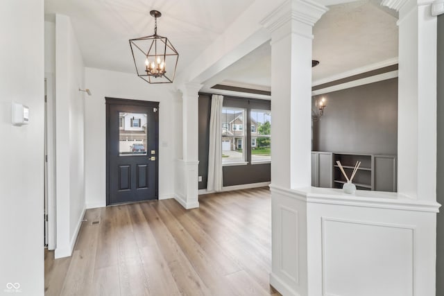 951 Parker Ln, Westfield, IN 46074 - foyer entrance with light wood finished floors, ornate columns, a chandelier, and baseboards