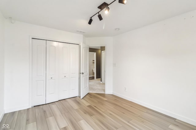 951 Parker Ln, Westfield, IN 46074 - unfurnished bedroom with light wood-style floors, a closet, baseboards, and a ceiling fan