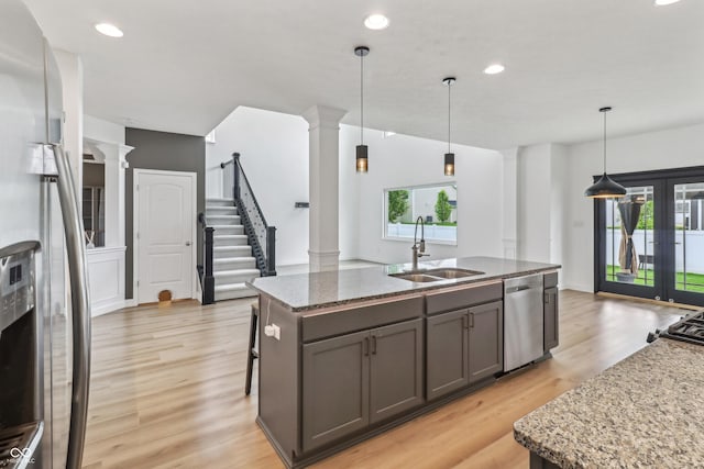 951 Parker Ln, Westfield, IN 46074 - kitchen with appliances with stainless steel finishes, ornate columns, a sink, light wood-type flooring, and plenty of natural light
