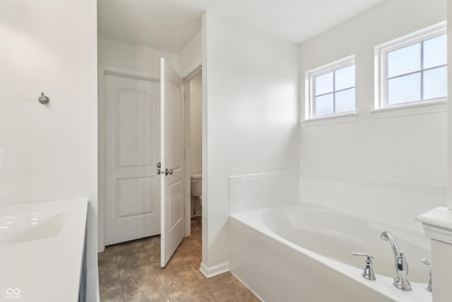 951 Parker Ln, Westfield, IN 46074 - full bathroom with a garden tub, toilet, baseboards, and vanity