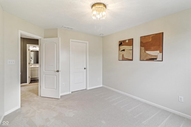 951 Parker Ln, Westfield, IN 46074 - unfurnished bedroom featuring light colored carpet, baseboards, and a chandelier