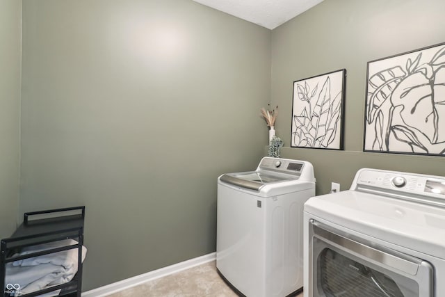 951 Parker Ln, Westfield, IN 46074 - laundry area featuring separate washer and dryer, baseboards, cabinet space, and light tile patterned floors