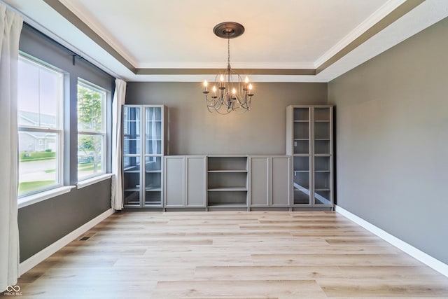 951 Parker Ln, Westfield, IN 46074 - unfurnished dining area with a chandelier, crown molding, light wood-style flooring, a tray ceiling, and baseboards