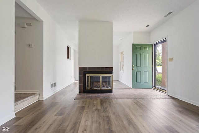 9572 Maple Way, Indianapolis, IN 46268 - unfurnished living room with wood finished floors, baseboards, and a tile fireplace