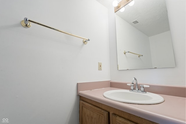 9572 Maple Way, Indianapolis, IN 46268 - bathroom featuring vanity and a textured ceiling