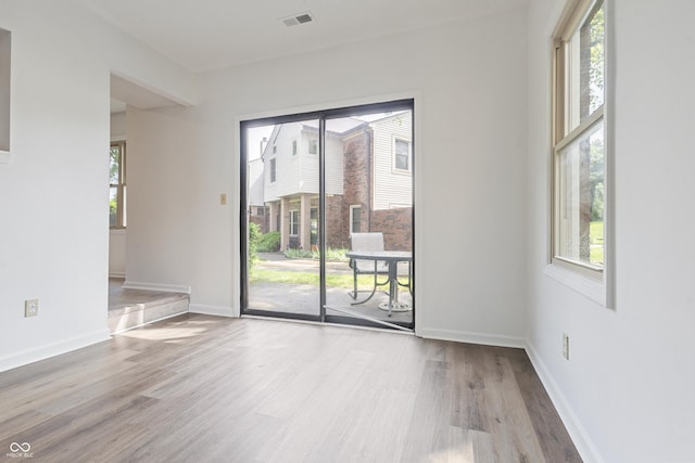 9572 Maple Way, Indianapolis, IN 46268 - spare room with wood finished floors, plenty of natural light, and baseboards