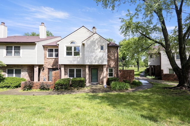 9572 Maple Way, Indianapolis, IN 46268 - view of property with brick siding, a front yard, and a chimney