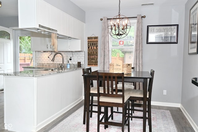 1236 Central Ave, Indianapolis, IN 46202 - dining space featuring wood finished floors and a chandelier