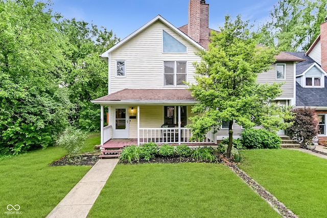 1236 Central Ave, Indianapolis, IN 46202 - traditional style home with a front lawn, covered porch, and a chimney