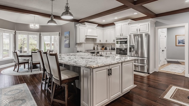 kitchen featuring stainless steel appliances, baseboards, dark wood-style floors, beam ceiling, and recessed lighting
