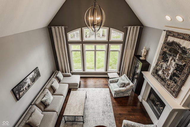 living area with dark wood-style flooring, a chandelier, recessed lighting, a glass covered fireplace, and high vaulted ceiling