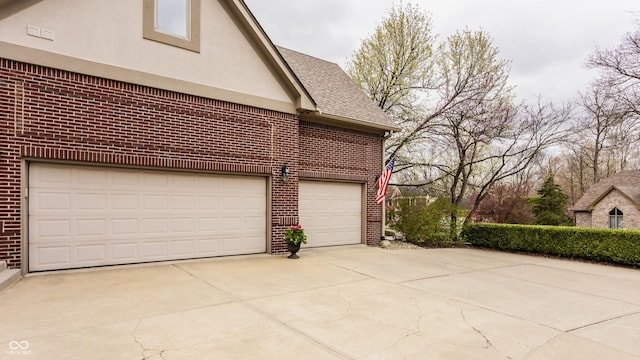 garage with concrete driveway