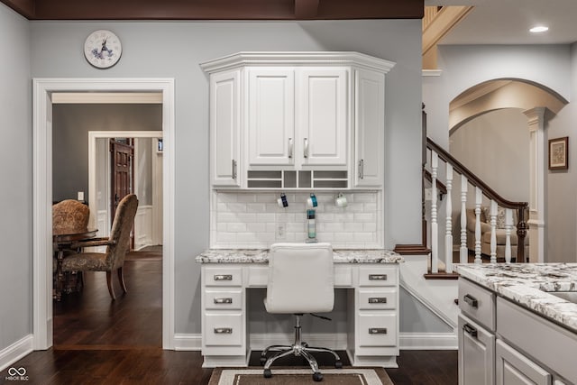 home office with dark wood finished floors, built in study area, baseboards, recessed lighting, and ornate columns