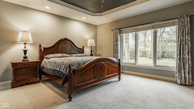 bedroom featuring carpet, baseboards, a tray ceiling, crown molding, and recessed lighting