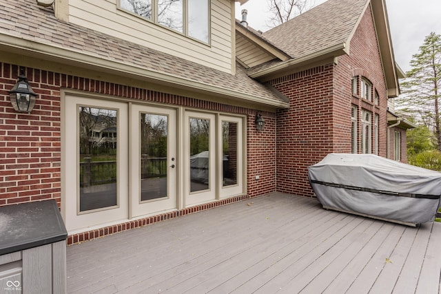 wooden deck with a grill