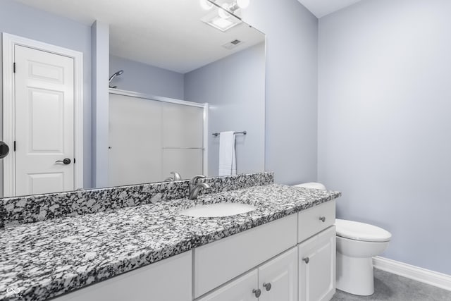 bathroom featuring vanity, an enclosed shower, baseboards, and toilet