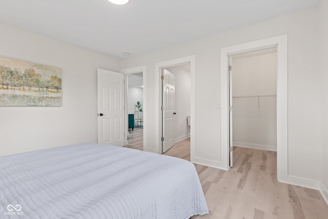 1108 N Ritter Ave, Indianapolis, IN 46219 - bedroom featuring light wood-style floors, a spacious closet, and baseboards