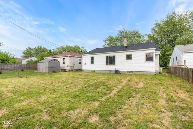 1108 N Ritter Ave, Indianapolis, IN 46219 - back of property with a chimney, an outdoor structure, and a storage shed