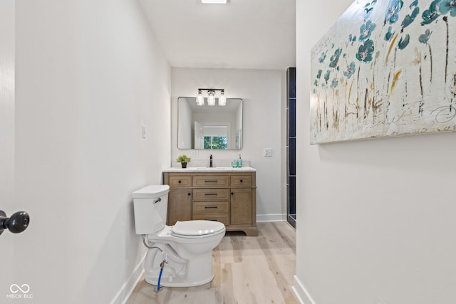 1108 N Ritter Ave, Indianapolis, IN 46219 - bathroom with wood finished floors, toilet, baseboards, and vanity