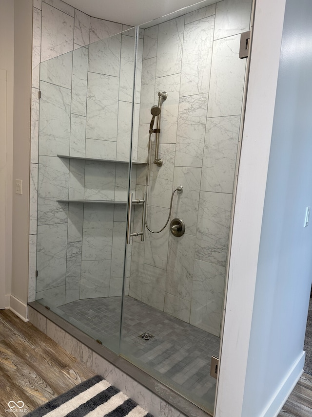 951 N Maiellen Dr, Greenfield, IN 46140 - full bathroom with wood finished floors, a shower stall, and baseboards