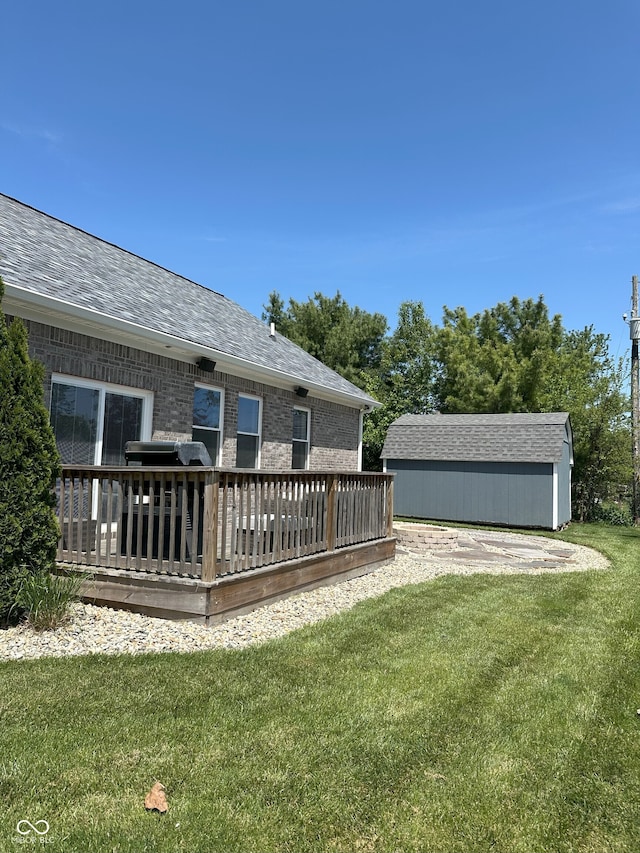 951 N Maiellen Dr, Greenfield, IN 46140 - view of grassy yard with a wooden deck and an outbuilding