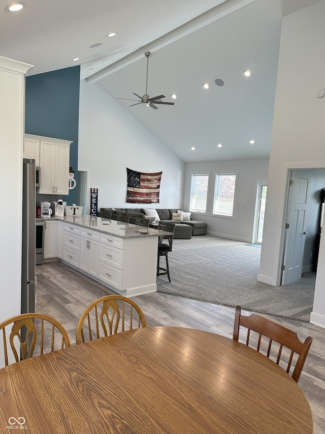 951 N Maiellen Dr, Greenfield, IN 46140 - dining area with high vaulted ceiling, light wood-style floors, a ceiling fan, beam ceiling, and baseboards