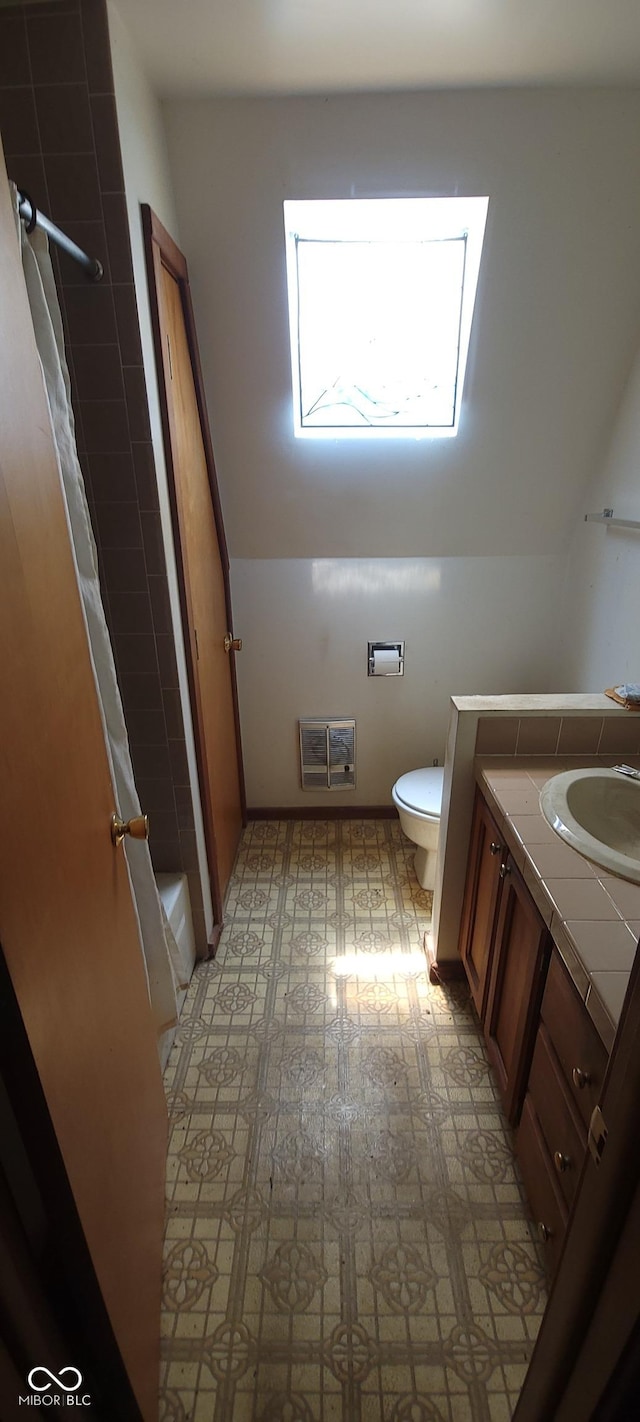 bathroom with tile patterned floors, vanity, a shower with shower curtain, and toilet