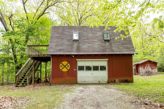 garage with a detached garage and driveway