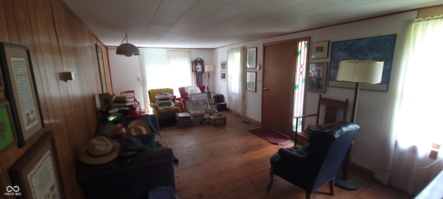 living area featuring wood finished floors and wood walls