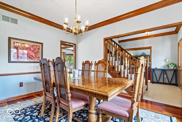 12082 Old Stone Dr, Indianapolis, IN 46236 - dining room with a chandelier, crown molding, light wood-style flooring, baseboards, and stairway
