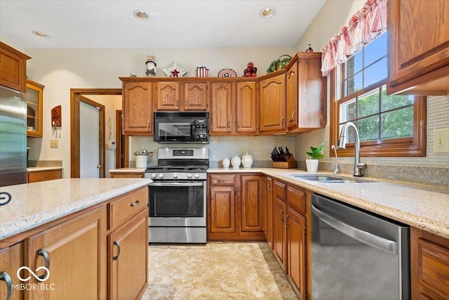 12082 Old Stone Dr, Indianapolis, IN 46236 - kitchen with appliances with stainless steel finishes, a sink, brown cabinets, backsplash, and recessed lighting