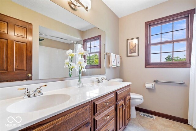 12082 Old Stone Dr, Indianapolis, IN 46236 - bathroom featuring baseboards, toilet, double vanity, a shower with shower curtain, and tile patterned floors