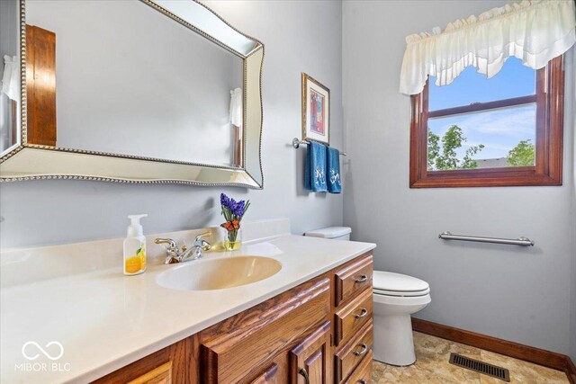 12082 Old Stone Dr, Indianapolis, IN 46236 - bathroom featuring baseboards, toilet, and vanity