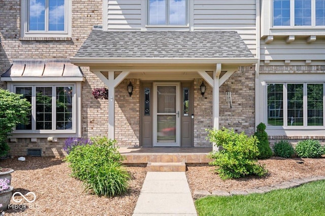12082 Old Stone Dr, Indianapolis, IN 46236 - doorway to property featuring brick siding, roof with shingles, and covered porch
